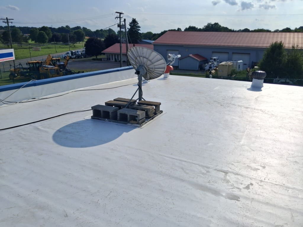 White flat roof with satellite dish